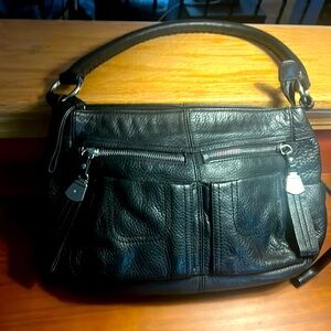 Black leather shoulder bag with plenty of exterior and interior pockets.